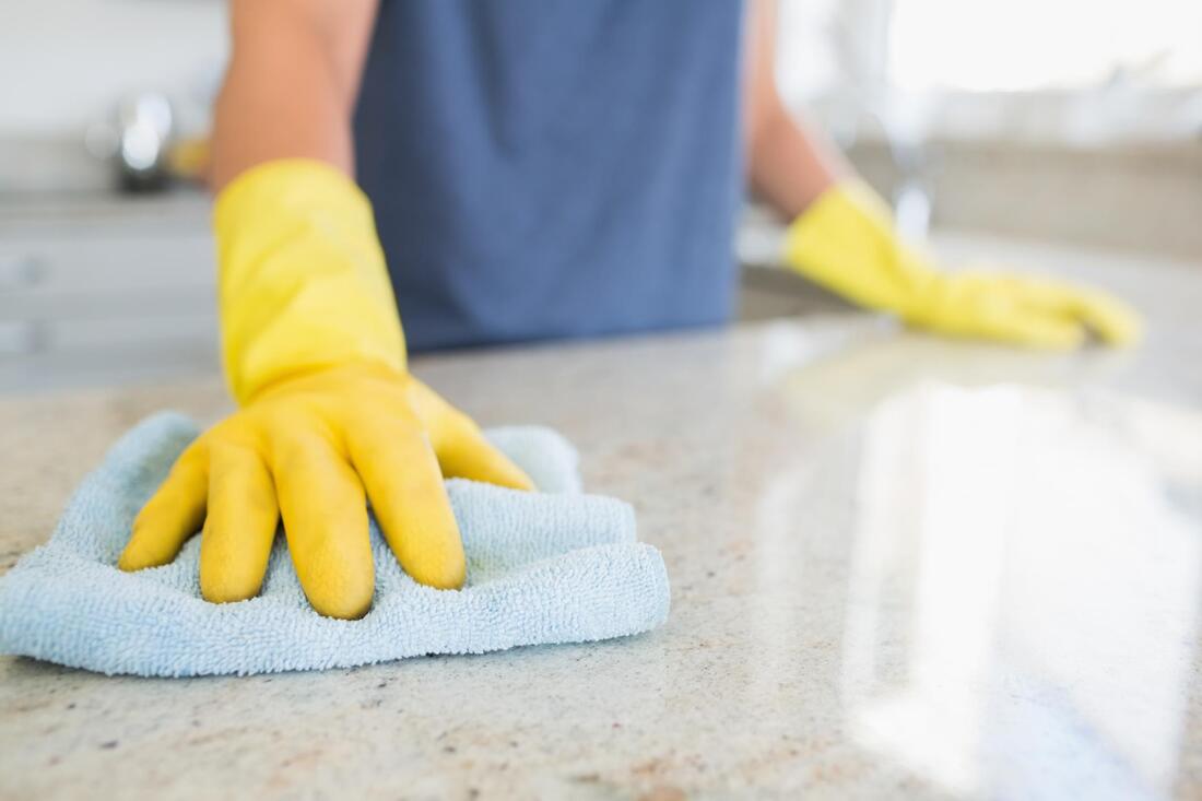 worker in gloves using a towel